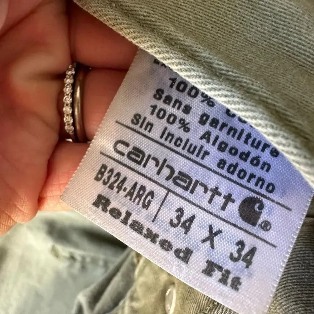 Distressed Carhartt relaxed fit olive green pants some staining  Size 34 x 34